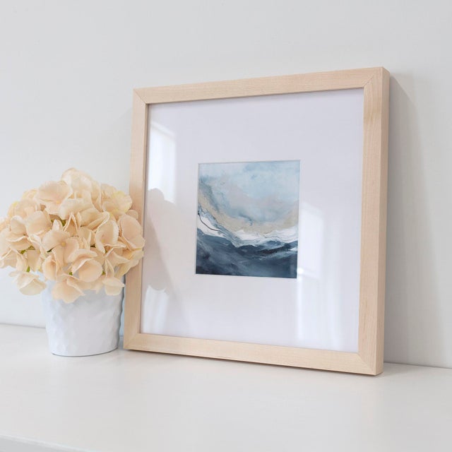 A crisp coastal palette of fresh blue tones mingling with taupe and white creates a classic feeling in this seascape. This...