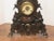 Very unusual mantel clock, with a cast iron face and brown wooden box. The clock is in working condition. As with any...