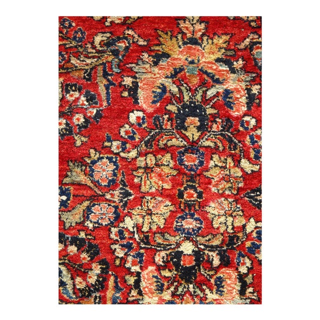 This is an antique handmade rug from the early 20th century. The piece was crafted from lamb's wool on a cotton foundation...