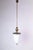 A 1950s sleek pendant in brass with an original opaline glass shade. The brass is lacquered in the pics. The total height...