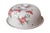 A French stoneware cheese plate with a domed lid. Hand-painted pink and yellow flowers with green leaves are set against a...