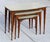 Discover a unique and hard-to-find set of vintage mid-century modern nesting tables, complete with neutral beige tops and...