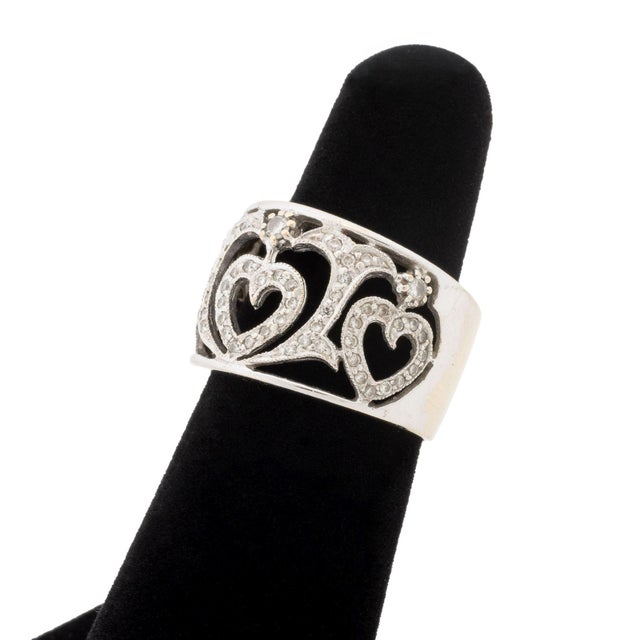18K White Gold Heart Motif Openwork Pave Diamond Ring, designed with openwork hearts and ribbons, brightly polished and...