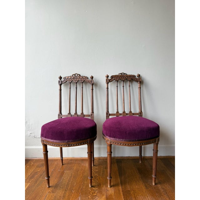 The Louis XVI Chair features a chic crimson upholstered cushion, showcasing refined neoclassical design and expert...