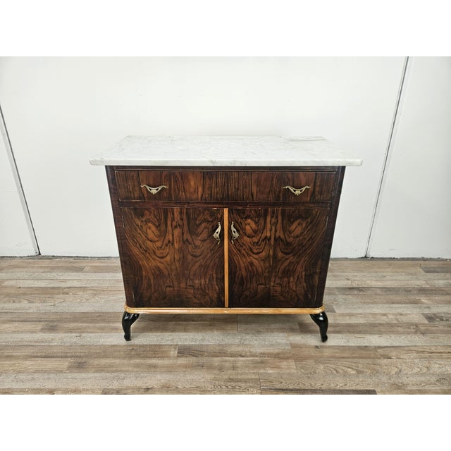 A 1950s Art Deco vanity unit clad in mahogany burl with maple trim and lacquered legs. It can be used in a variety of...