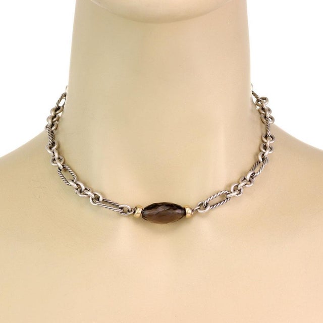 This authentic pendant and chain is by David Yurman, it is crafted with sterling silver with 18k yello gold accent...