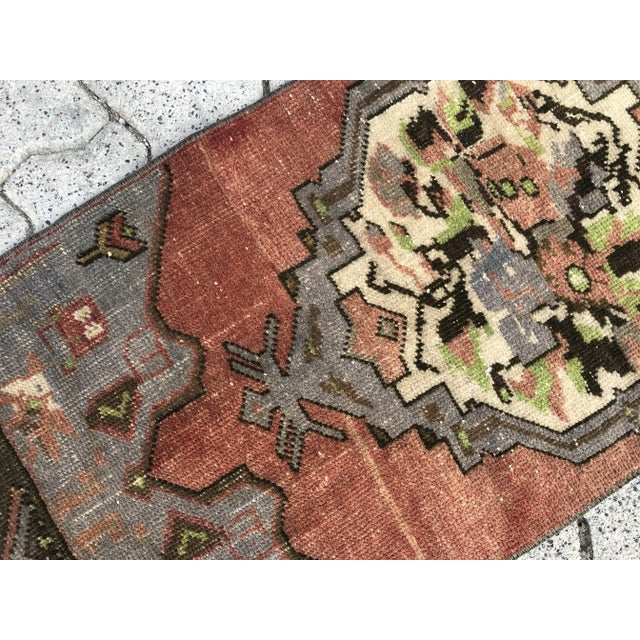 This is a vintage Turkish Oushak rug from the 1960s. The piece was hand-knotted.