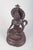 Buddhist bronze figure. Seated Buddhist figure executed in patinated bronze with an elaborate headdress, pierced halo and...