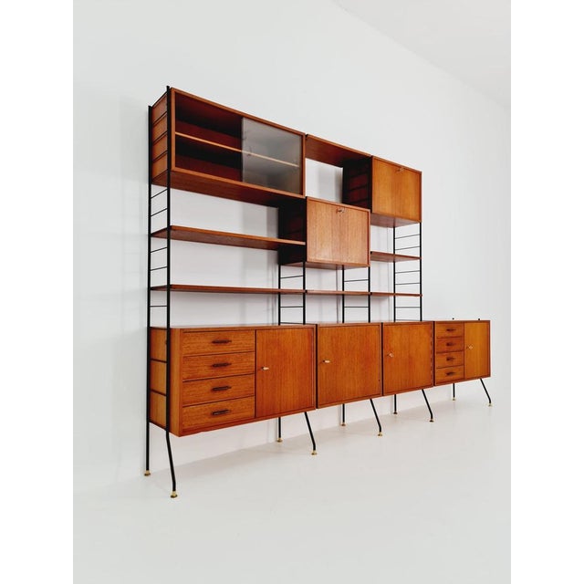 Freestanding string shelf system unit, bookcase, teak & metal, by Silverschild Germany, 1950s. The individual units and...