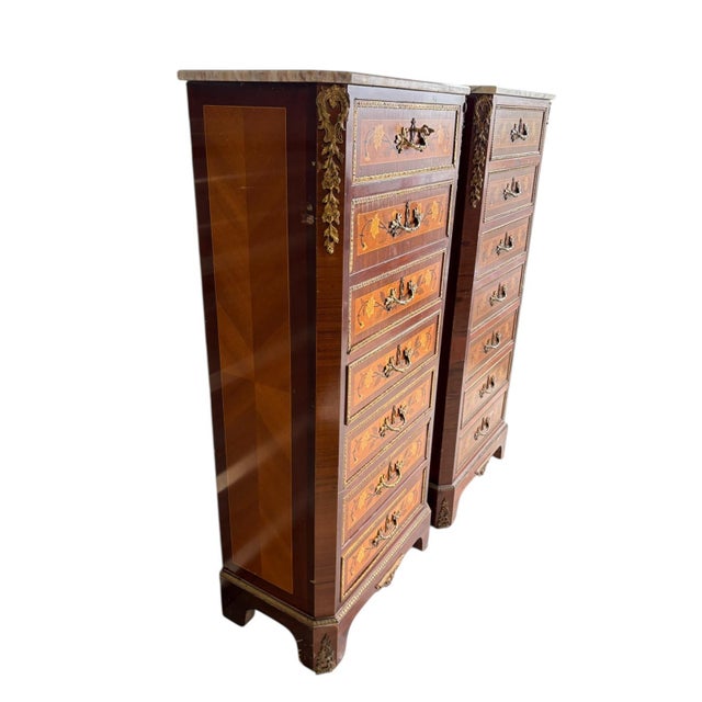 This exquisite pair of tall French cabinets (commodes à chaussures / semainiers) showcases exceptional craftsmanship in...