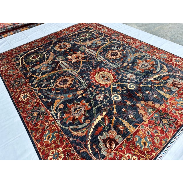 This hand-knotted Sultanabad rug features a grand scrolling vine and palmette medallion design in rust, gold, and sage on...