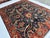 This hand-knotted Sultanabad rug features a grand scrolling vine and palmette medallion design in rust, gold, and sage on...