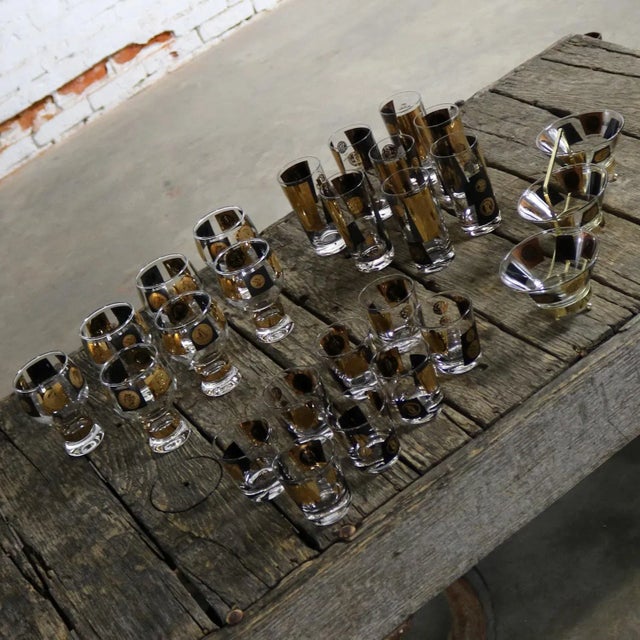 Very large extensive set of coin mid-century modern barware and glasses by Cera. The set consisting of eight highball...