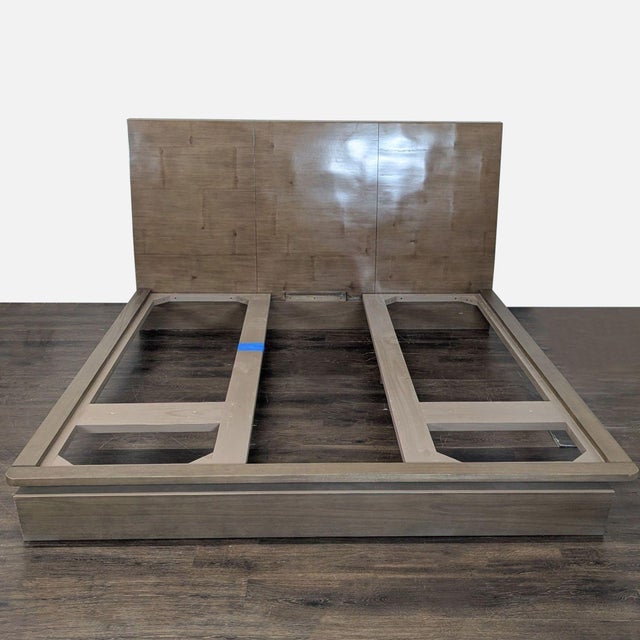 This Restoration Hardware platform bed frame features a modern, low-profile design with a tall wooden headboard. The...