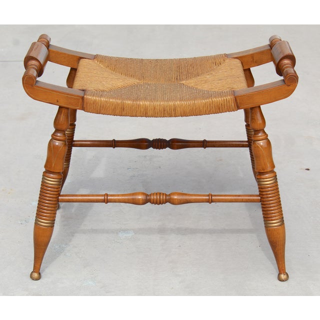 This charming vintage Hitchcock-style maple bench showcases classic American craftsmanship and timeless design....