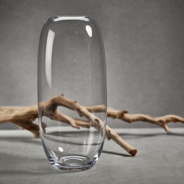 Create an impressive statement in any space in your home or office by using our 19.75-inch tall blown clear glass vase. A...