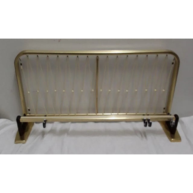 vintage wall wardrobe, gold-colored aluminum with white trim and adjustable hooks and a rear parcel shelf of white vinyl...