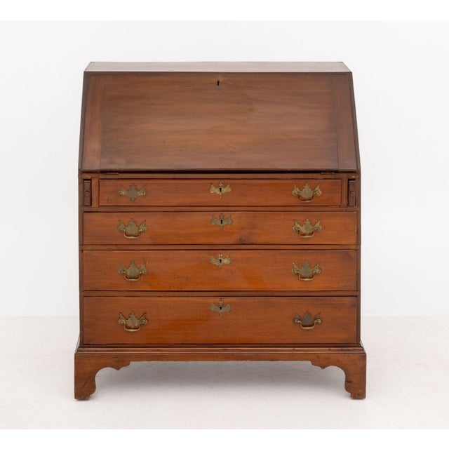 Chippendale Style Mahogany Slant Front Desk, the writing surface opening to short drawers above graduated long drawers....