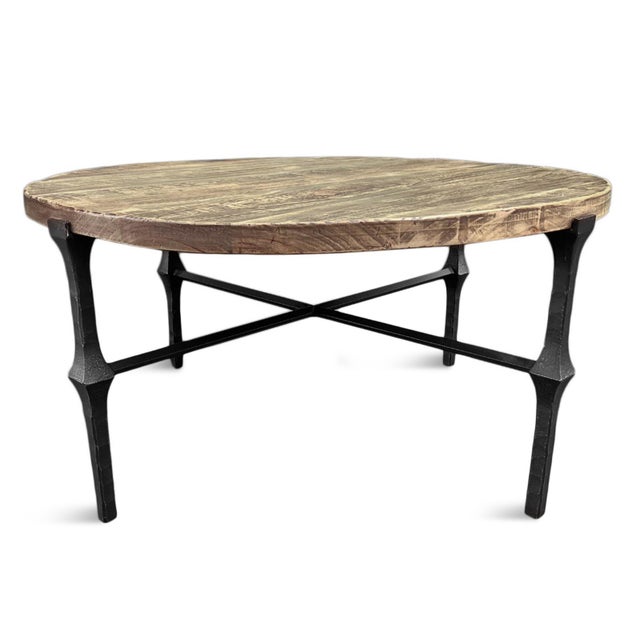 Beautiful modern farmhouse style round coffee table with black hammered iron legs and salvaged pine wood top. Each will...