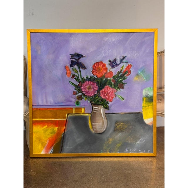 Still life of a bouquet in a tall vase, painted in bright pinks, reds and purples against a lavender wall and gray...
