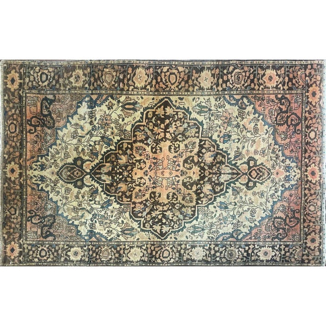 his charming antique Persian Sarouk Feraghan rug, measuring approximately 3'5" x 4'5", is a beautiful example of the...