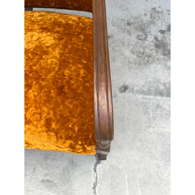 A beautiful mid century crushed orange velvet rocking chair. A strong maple frame with muted brown coloring compliments...