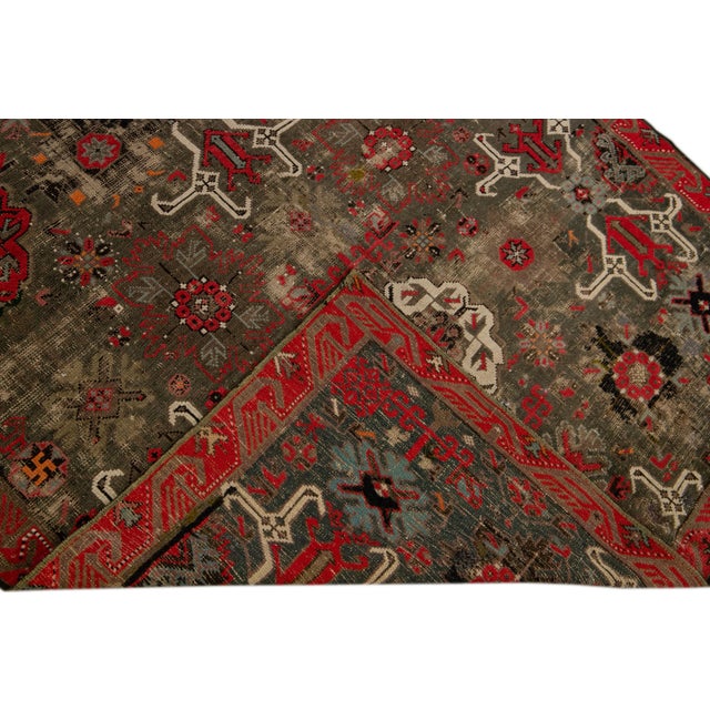 Beautiful Antique Malayer hand-knotted wool rug with a brown field. This Malayer rug has an orange, red, beige, and blue...