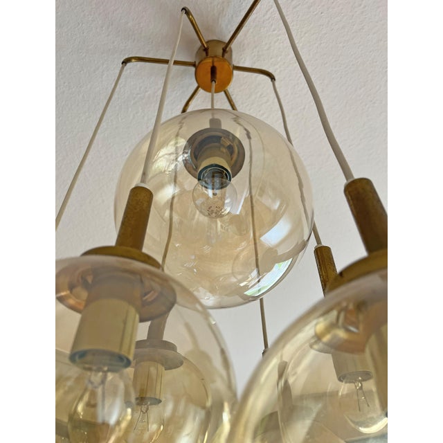 For sale: a seven-light cascade chandelier by Glashütte Limburg Brass and amber-colored glass Dimensions: Height: approx....