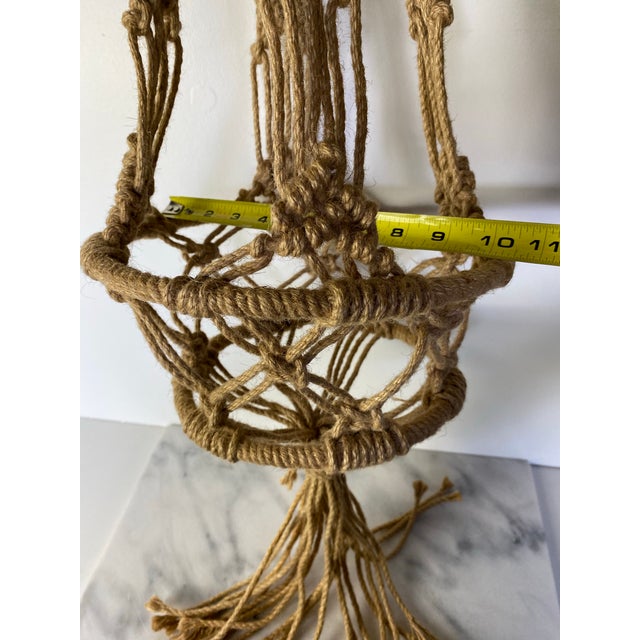 Classic vintage macramé plant hanger handcrafted from natural fiber rope in the relaxed, earthy style that defined 1970s...