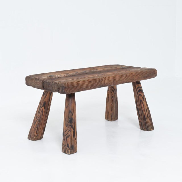 This rustic wooden bench was hand-crafted from pinewood. We date it back to the 1950s. The wood has a beautiful pattern...