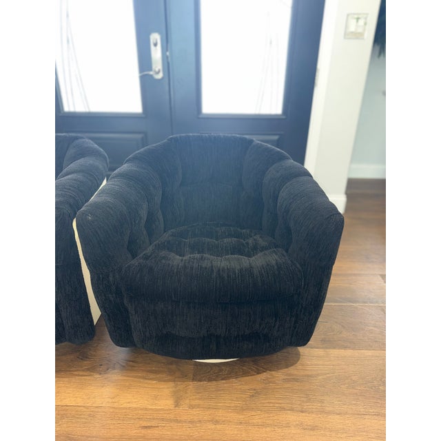 An iconic pair of authentic Milo Baughman swivel lounge chairs for Thayer Coggin, manufactured in 1973 and retaining their...