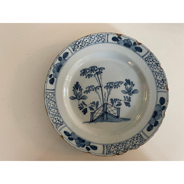 A striking companion pair of antique Chinese export blue-and-white porcelain plates, likely dating to the Qing dynasty,...