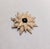 1960s goldtone medallion or flower with cabochon faux-emerald center brooch with security clasp and a loop so it can be...