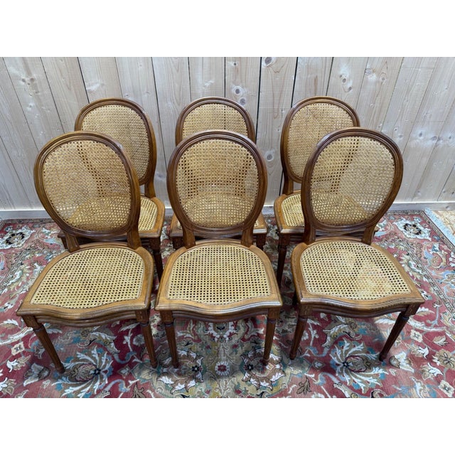 Set of six Louis XVI style medallion chairs in solid wood and cane. Made in 1996, these chairs feature the characteristic...