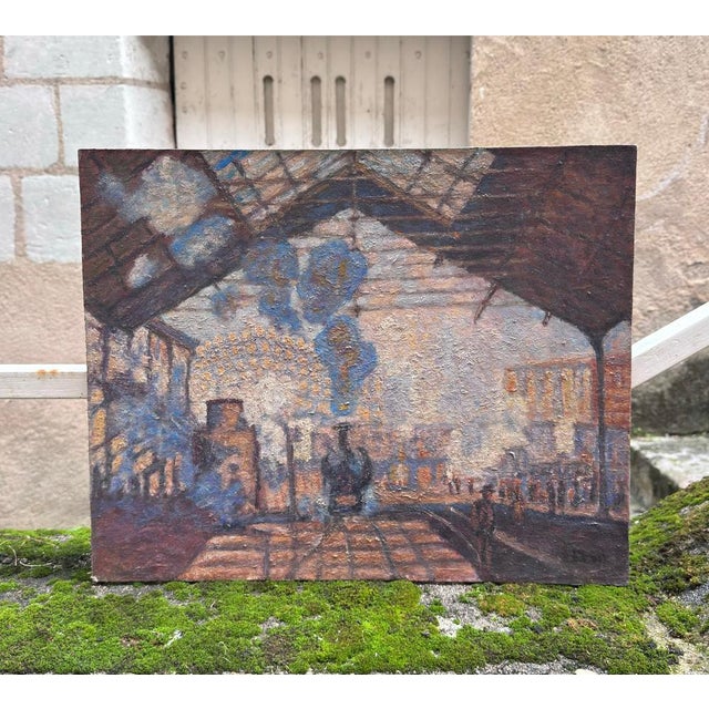 This painting on panel depicts the interior of a bustling urban train station, seen from a vantage point sheltered beneath...