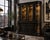 A dramatic architectural display hutch reimagined in a deep matte black lacquer finish with warm antique gold interior...