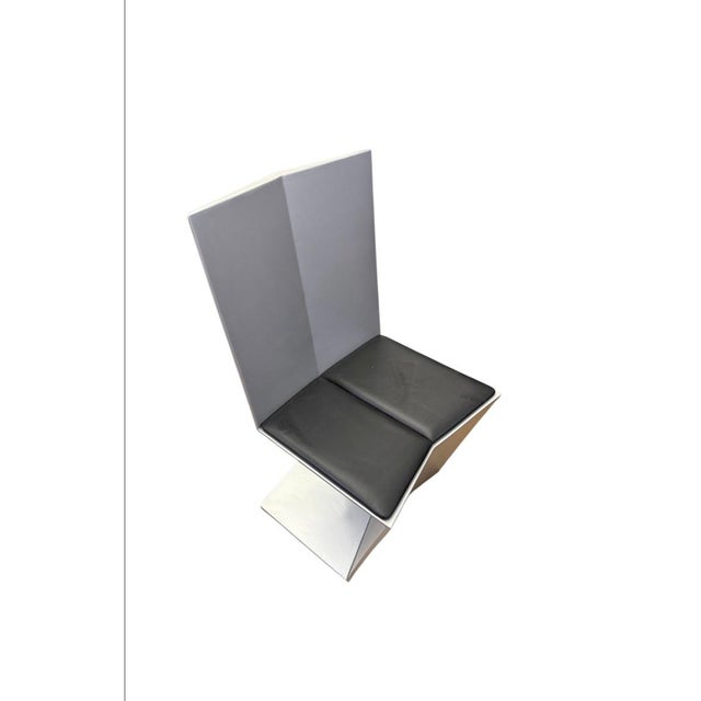 Sculptural pair of aluminum chairs with leather detachable seat , the chairs are impressive from every angle and are...