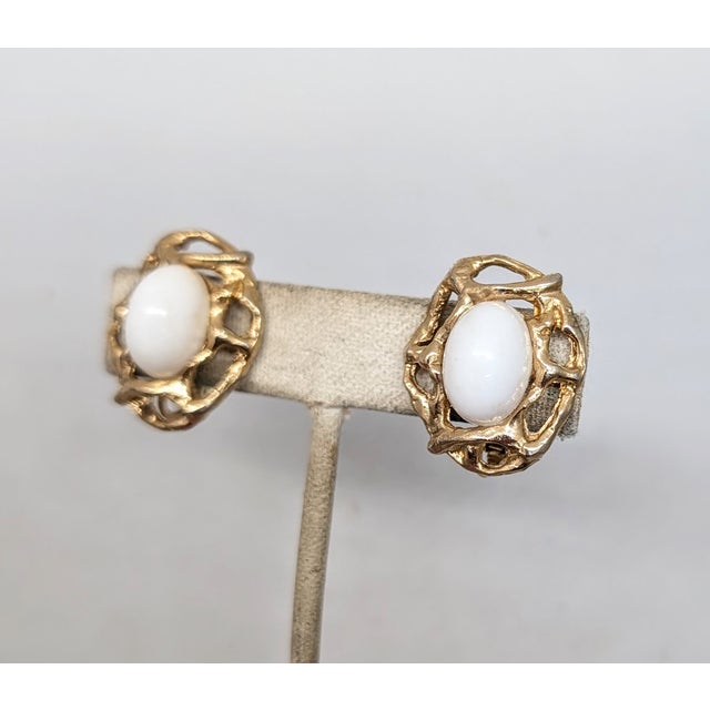 Modernist openwork white rhinestone cabochon clip and screw back earrings. Marked "Napier." Date to 1973. Measure: 1 inch...