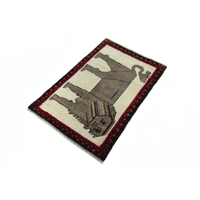 This hand-knotted Gabbeh nomad rug, measuring 94 x 61 cm, captivates with its highly stylized lion motif and the...