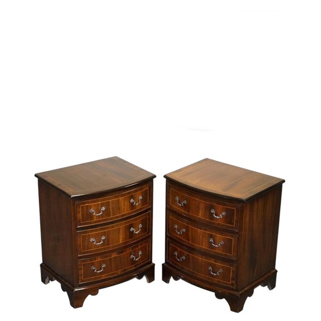 A charming restored vintage English pair of bedside tables / nightstands, featuring elegant proportions, practical...