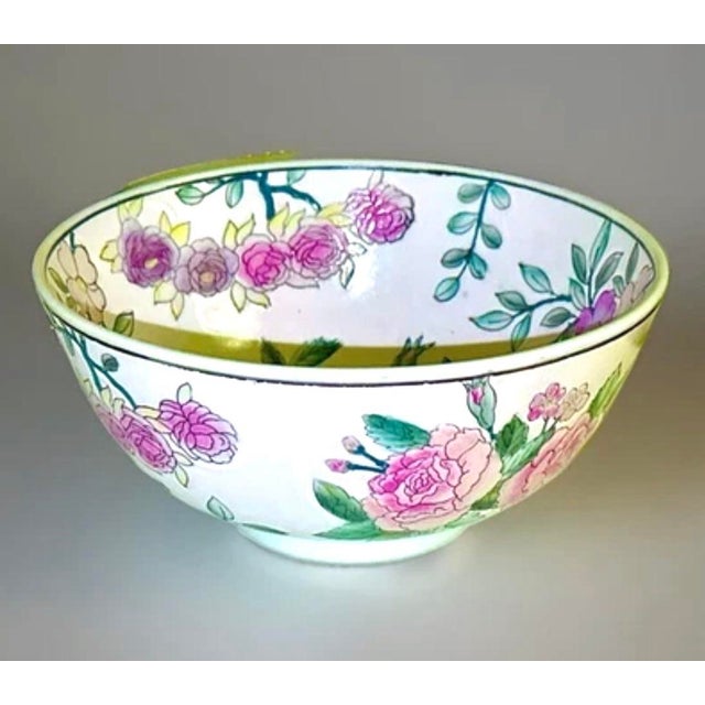 A vibrant hand‑painted Macau porcelain bowl featuring lush pink roses, green foliage, and rich detailing inside and out....