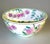 A vibrant hand‑painted Macau porcelain bowl featuring lush pink roses, green foliage, and rich detailing inside and out....