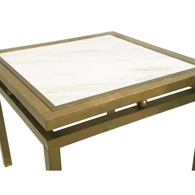 This elegant coffee table was produced in Italy around the 1970s. It is made from a brass structure with a white marble...