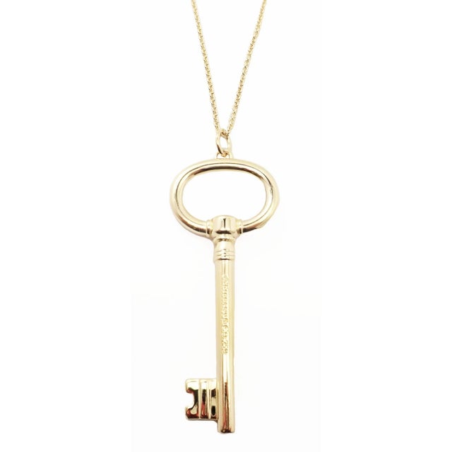 Tiffany & Co. 18k Yellow Gold Oval Key Pendant Necklace Details: Metal: 18k Yellow Gold Pendant: 1" x 2.5" Weight: 24...