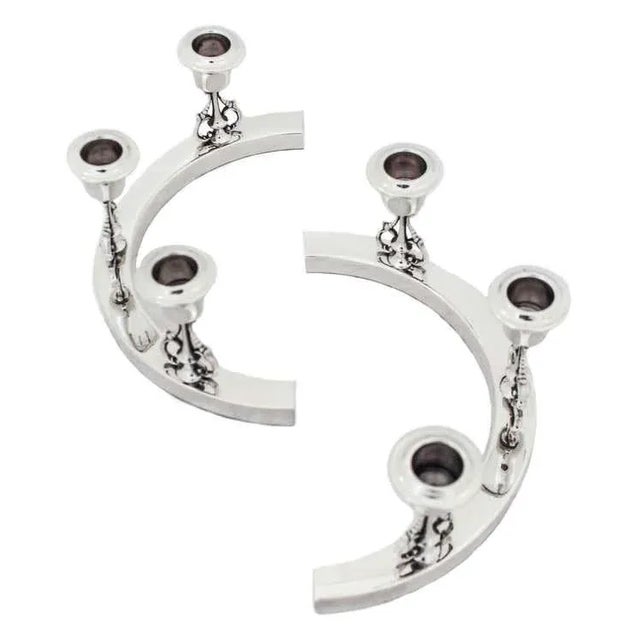 We are thrilled to offer you this pair of sterling silver candelabras. A unique twist on the conventional style...