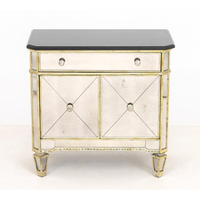Hollywood Regency Style Mirrored Cabinet, the silvered painted frame with black marble top above two short drawers above...