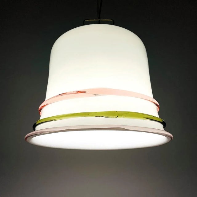 Retro Murano glass pendant lamp made in Italy in the 1970s. The lamp is equipped with a metal base. Milky white glass is...