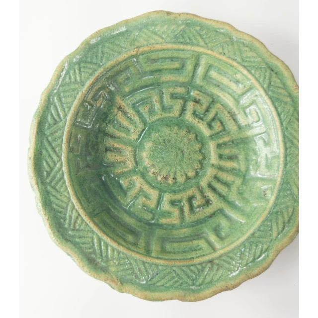 We are selling this small Chinese green glazed and molded plate, possibly Tang or Han dynasty period. Condition: Small...