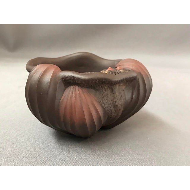 The brushwasher in brown Yixing clay, the typical Zisha. It is in a free form shape like a half shell. On the undulating...