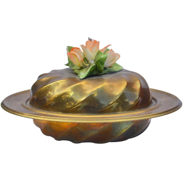 Vintage handcrafted brass lidded bowl in an ornate shape and composition featuring a fine porcelain floral design on lid....